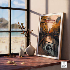 Eindhoven Print | Netherlands Home Decor Walll Art framed on a wooden table by a window with autumn scenery.