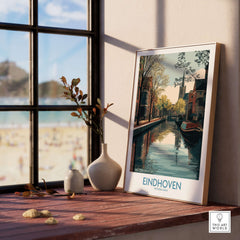 Eindhoven Poster Netherlands Canal Art Print | Historic City Poster displayed on a wooden table by a window.