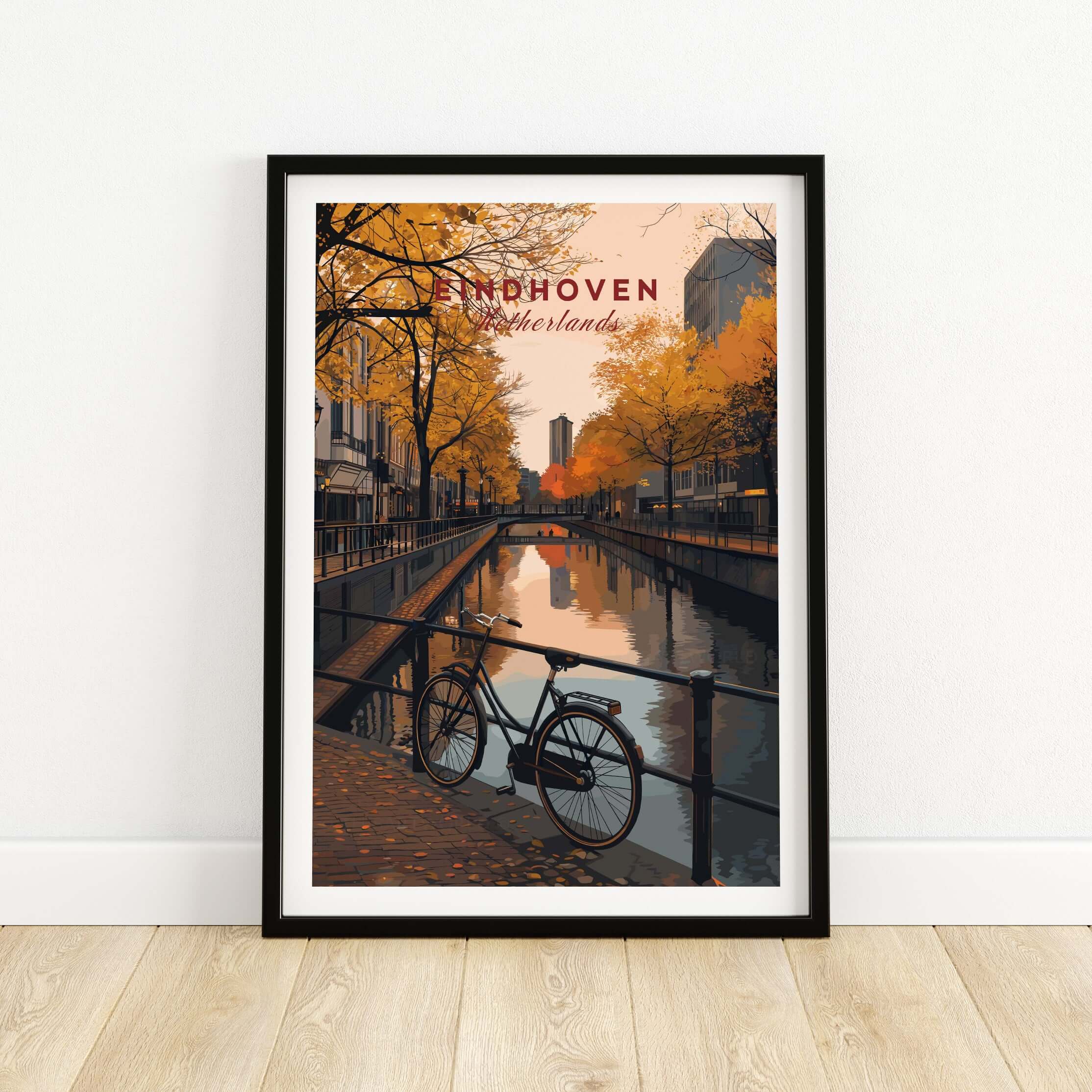 Eindhoven Print | Netherlands Home Decor Walll Art featuring a serene canal scene with autumn trees and a bicycle.