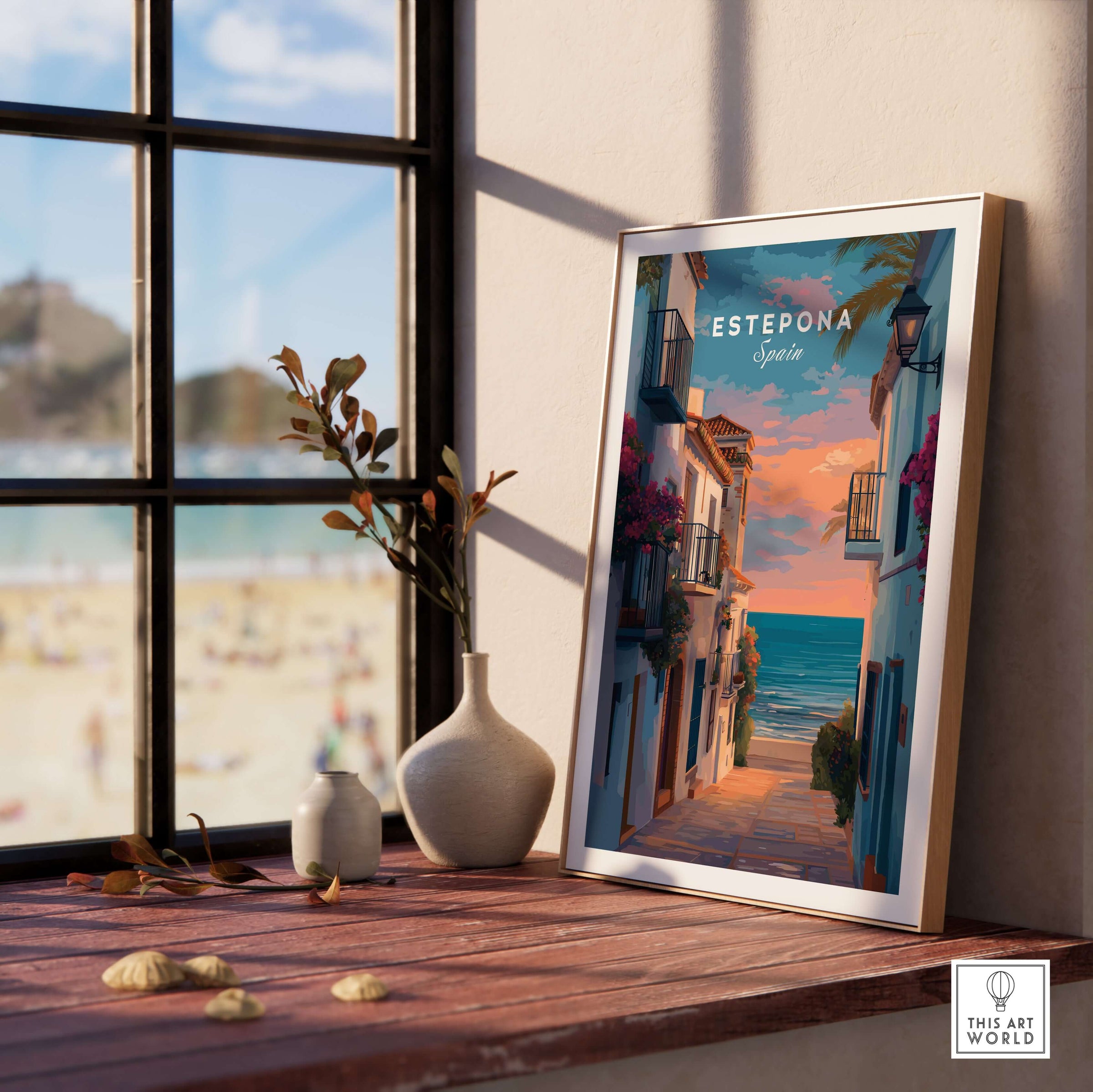 Estepona Balcony View Beach Print | Andalusian Home Decor framed art on a wooden table, with beach view in the background.
