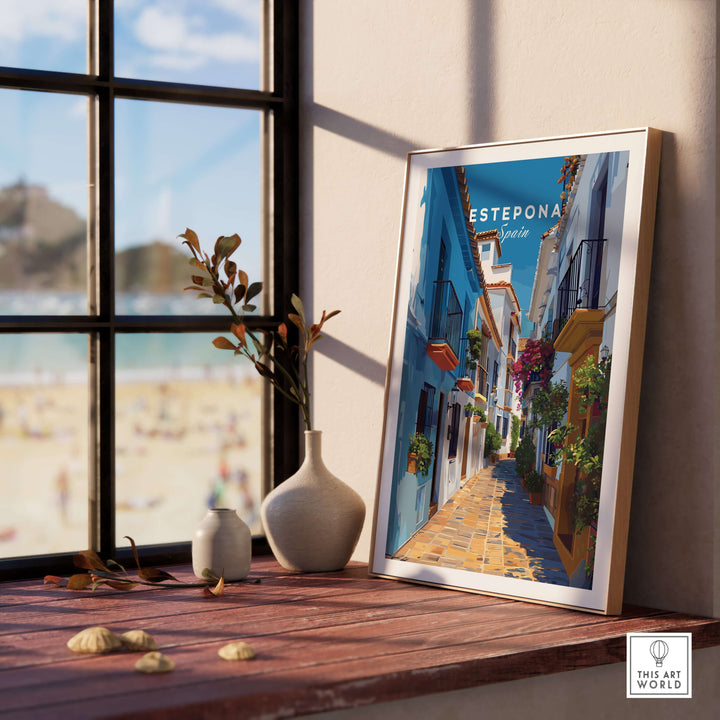 Estepona Flower Alley Print | Mediterranean Travel Wall Art displayed on a table by the window with a beach view.