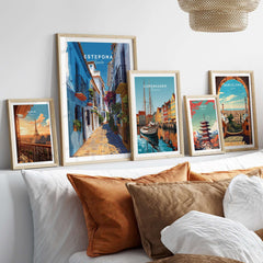 Estepona Flower Alley Print | Mediterranean Travel Wall Art displayed among other travel prints on a cozy sofa.