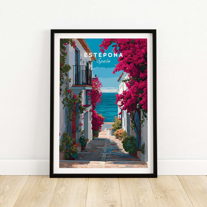 Estepona Old Town Sea View Print | Mediterranean White Village Decor framed print showcasing a coastal street with vibrant flowers.