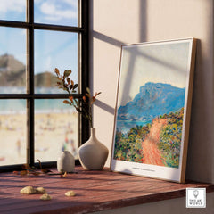 Exhibition Art Print Claude Monet The Corniche near Monaco Impressionist Landscape Poster displayed by a sunny window.