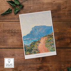 Exhibition Art Print Claude Monet The Corniche near Monaco Impressionist Landscape Poster on wooden surface.