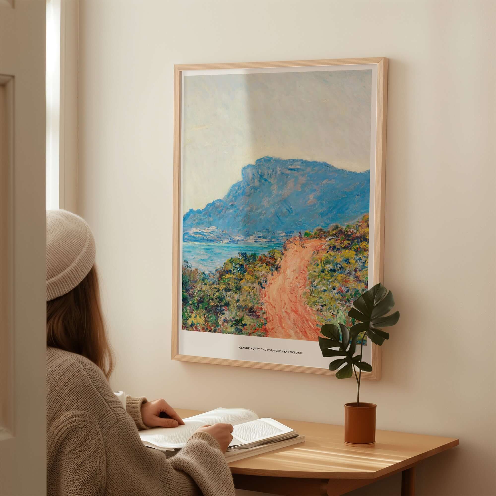 Exhibition Art Print Claude Monet The Corniche near Monaco Impressionist Landscape Poster displayed in a cozy interior setting.