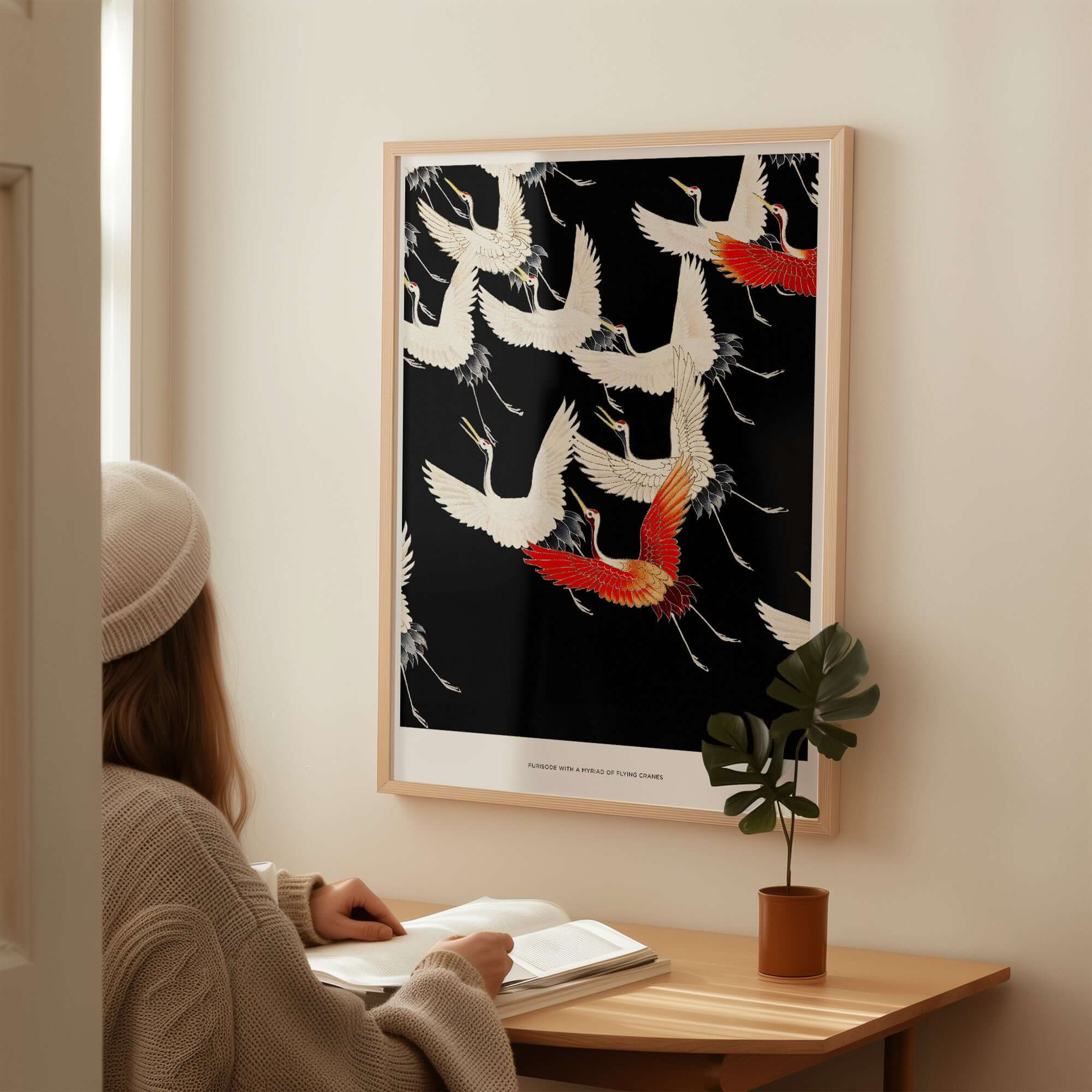 Exhibition Art Print Myriad of Flying Cranes Japanese Bird Pattern Poster Wall Art displayed on a wall with a person reading.