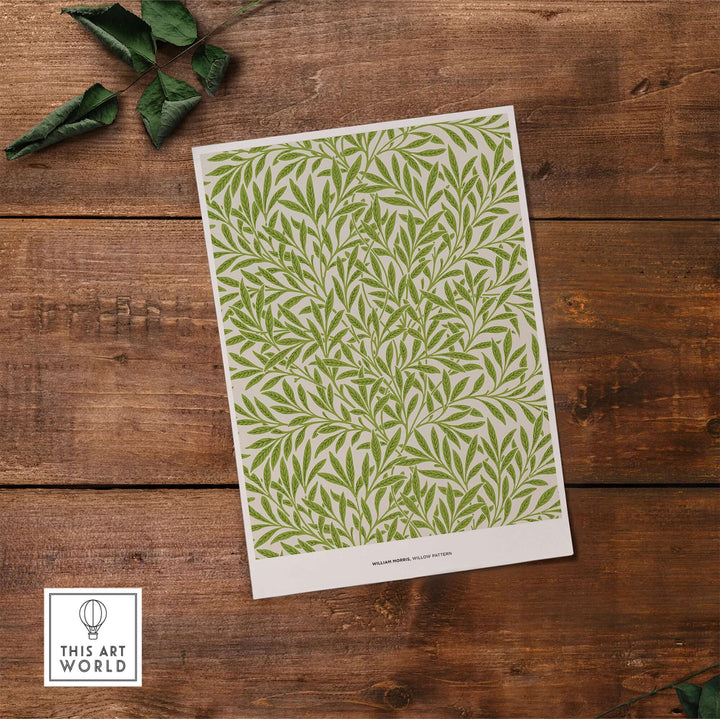 William Morris Willow Pattern green botanical art print on wooden background, showcasing intricate leaf design.
