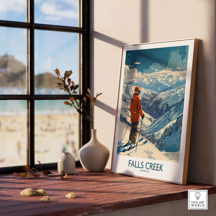 Falls Creek Australia ski poster displayed on a windowsill, showcasing snowy mountains and a skier.