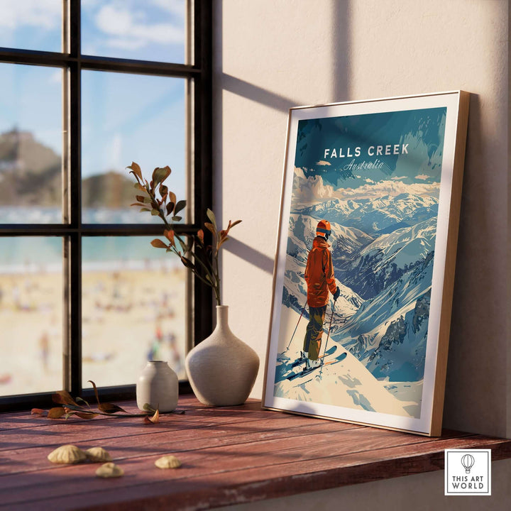 Framed Falls Creek Australia ski poster displayed on a wooden windowsill with decorative vases.