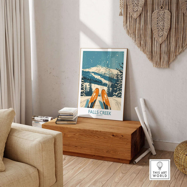 Falls Creek ski poster displayed on wooden table in cozy living room, featuring snowy mountain landscape with skis in foreground.