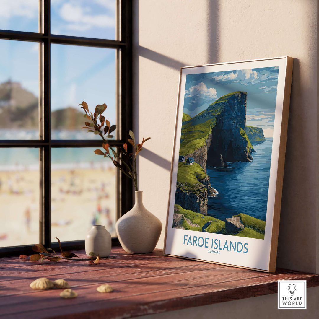 Faroe Islands Vágar Cliffs Art Print | Dramatic Coastal Landscape Poster displayed on a wooden table by a window.