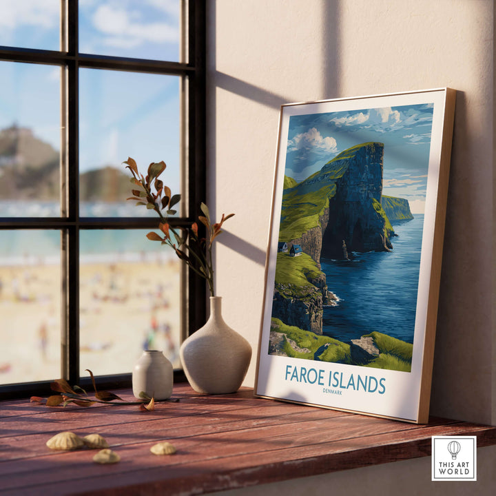 Faroe Islands Vágar Cliffs Art Print | Dramatic Coastal Landscape Poster displayed on a wooden table by a window.