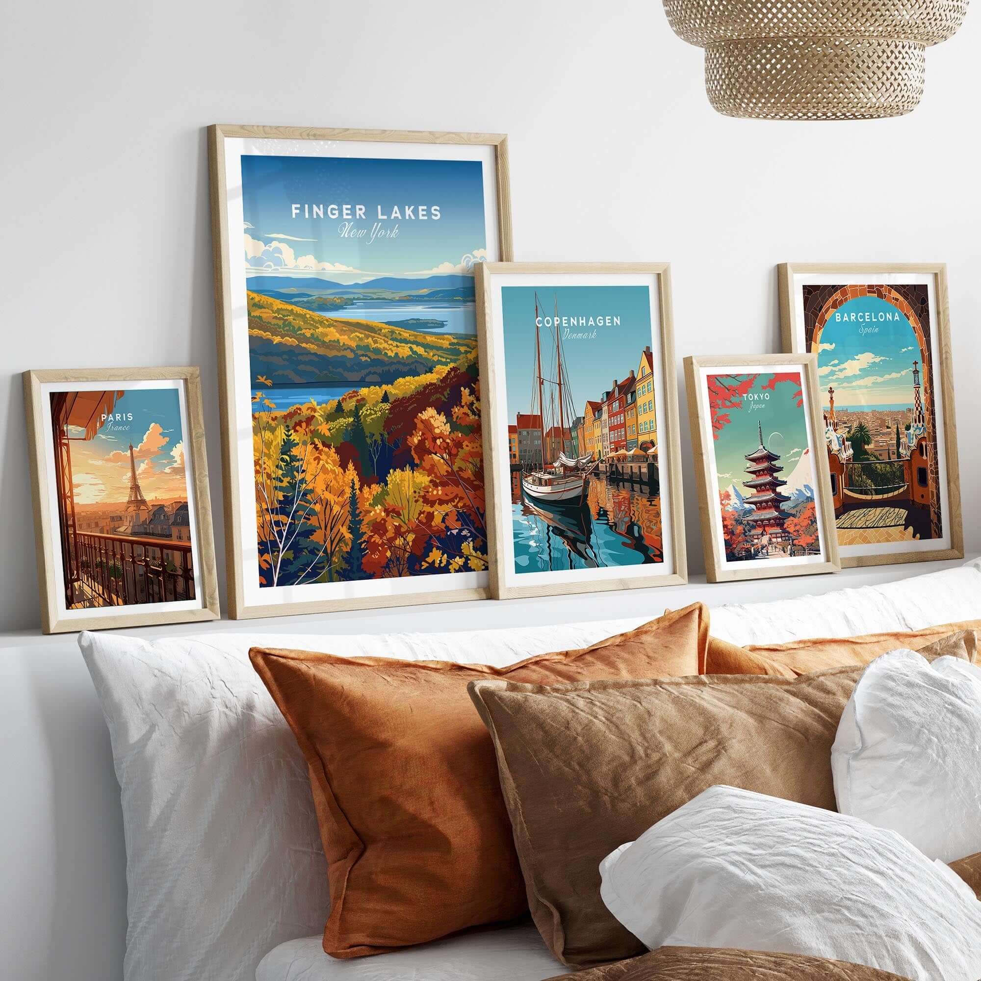 Finger Lakes Poster - New York displayed among other travel-themed framed posters on a modern bed.