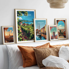 Finger Lakes Print - Wine Region displayed among framed artwork on a cozy bed with decorative cushions.
