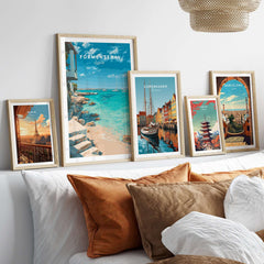 Formentera Mediterranean Sea View Print | Luxury Coastal Wall Decor displayed among other travel posters on a stylish couch.