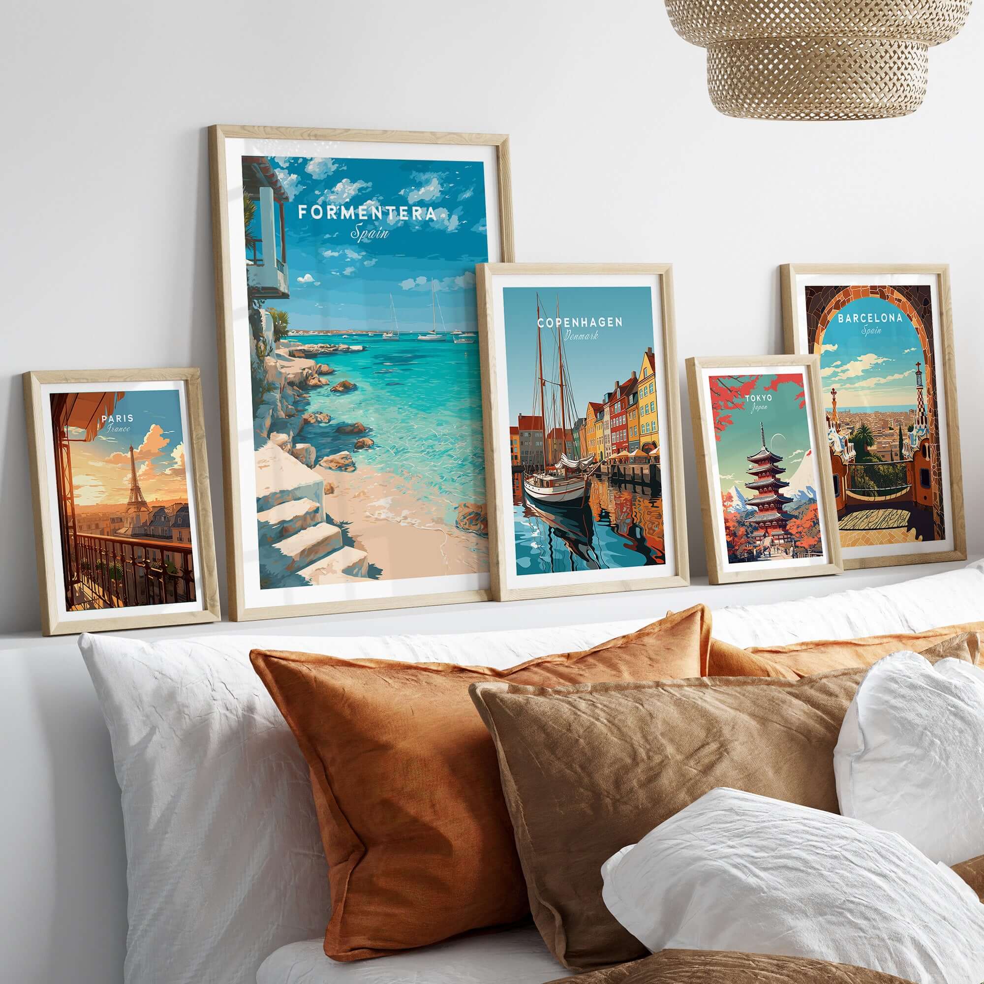 Formentera Mediterranean Sea View Print | Luxury Coastal Wall Decor displayed among other travel posters on a stylish couch.