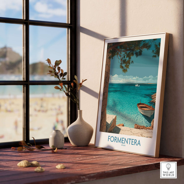 Formentera Spain Art Print | Beach Poster displayed on a table with a view of the beach through a window.