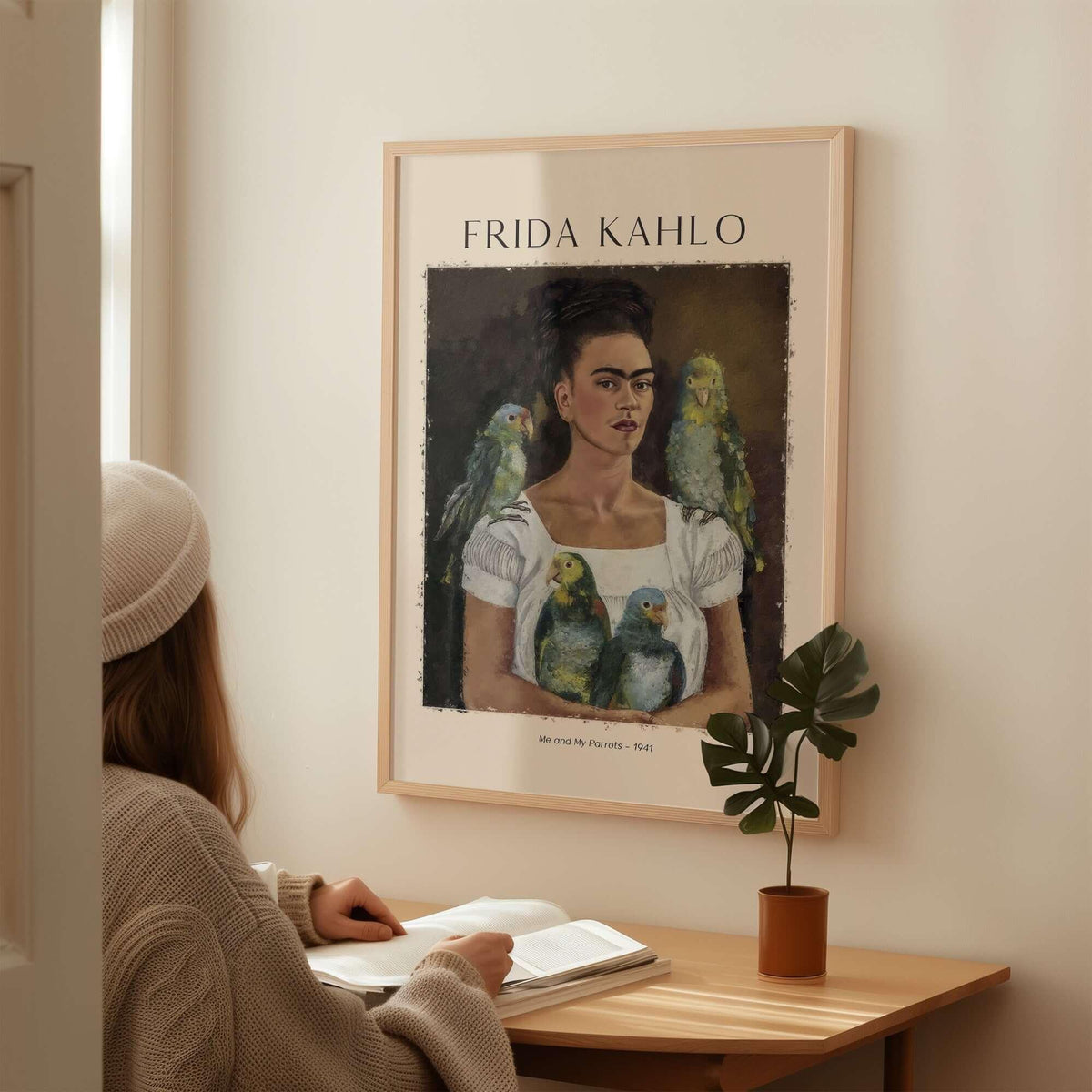 Frida Kahlo Me and My Parrots Self Portrait Art Print Poster Wall Art displayed on a wall, featuring a woman admiring it.