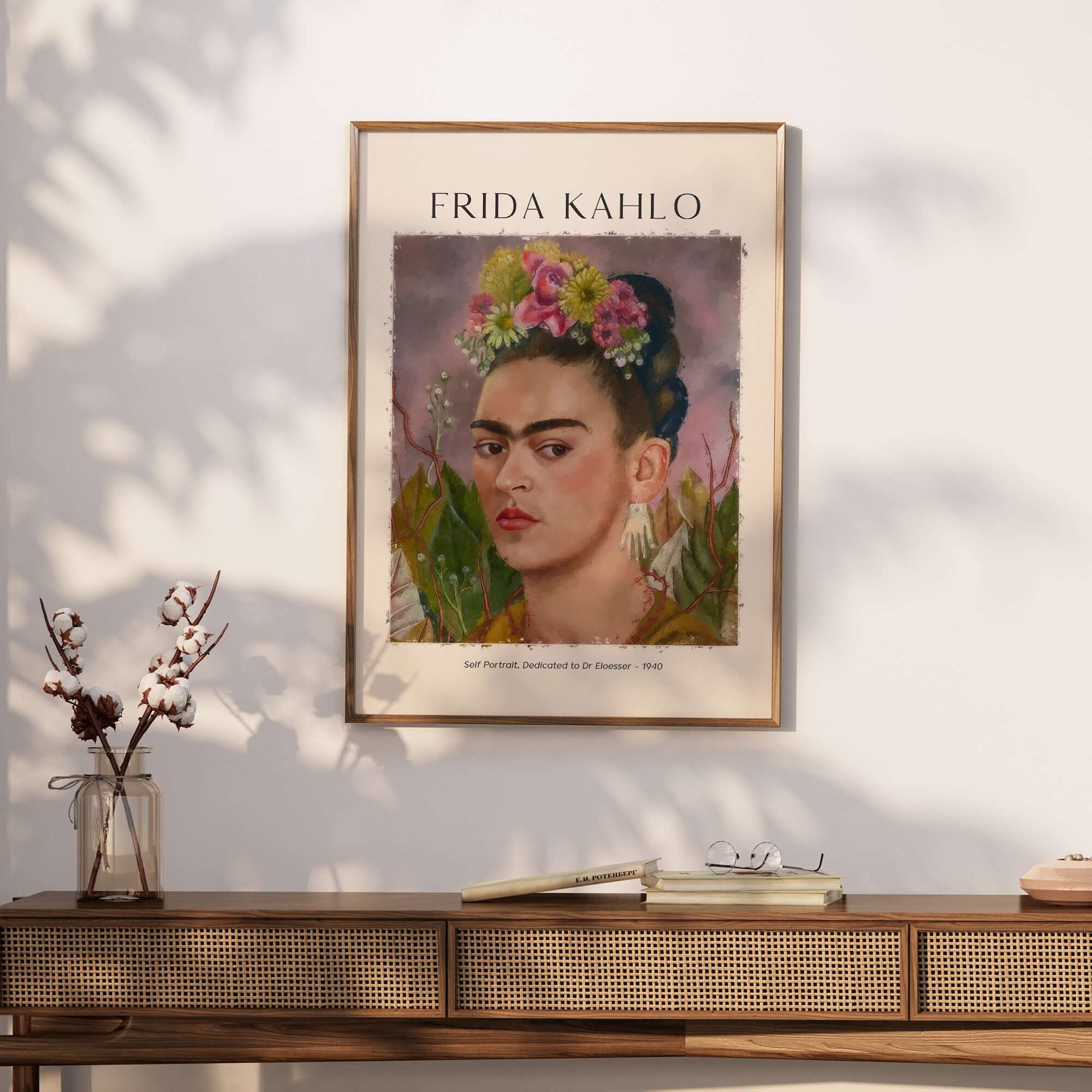 Frida Kahlo Self Portrait Dedicated Dr Eloesser Floral Poster Art Print displayed on a wall above a wooden console.