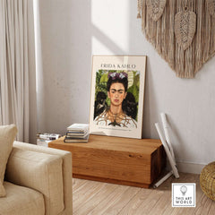Frida Kahlo Self Portrait with Thorn Necklace and Hummingbird Print displayed in a cozy living room setting.