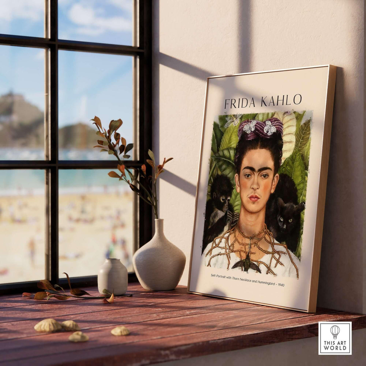 Frida Kahlo Self Portrait with Thorn Necklace and Hummingbird Print displayed in a stylish room with beach view.