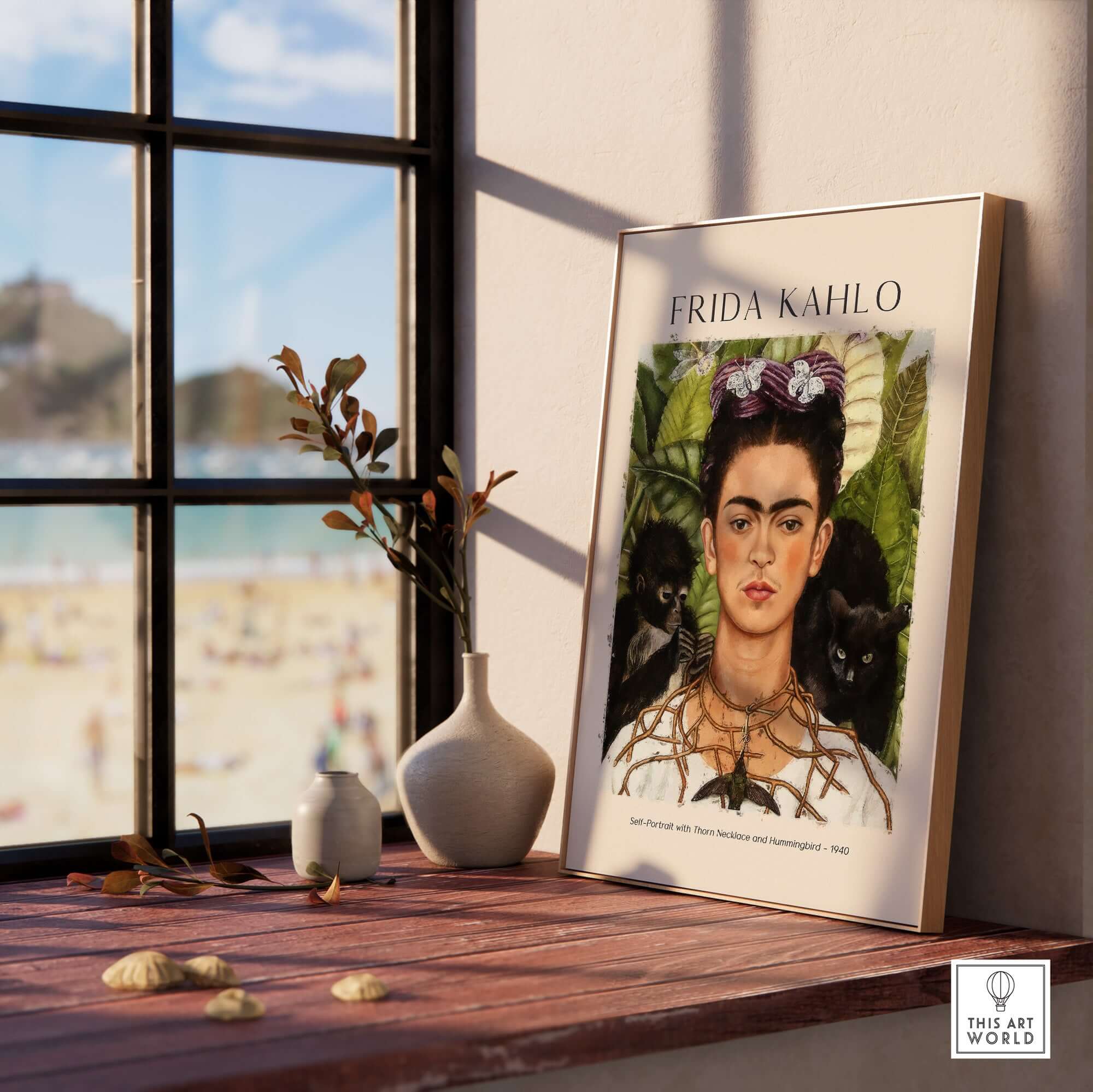 Frida Kahlo Self Portrait with Thorn Necklace and Hummingbird Print displayed in a stylish room with beach view.