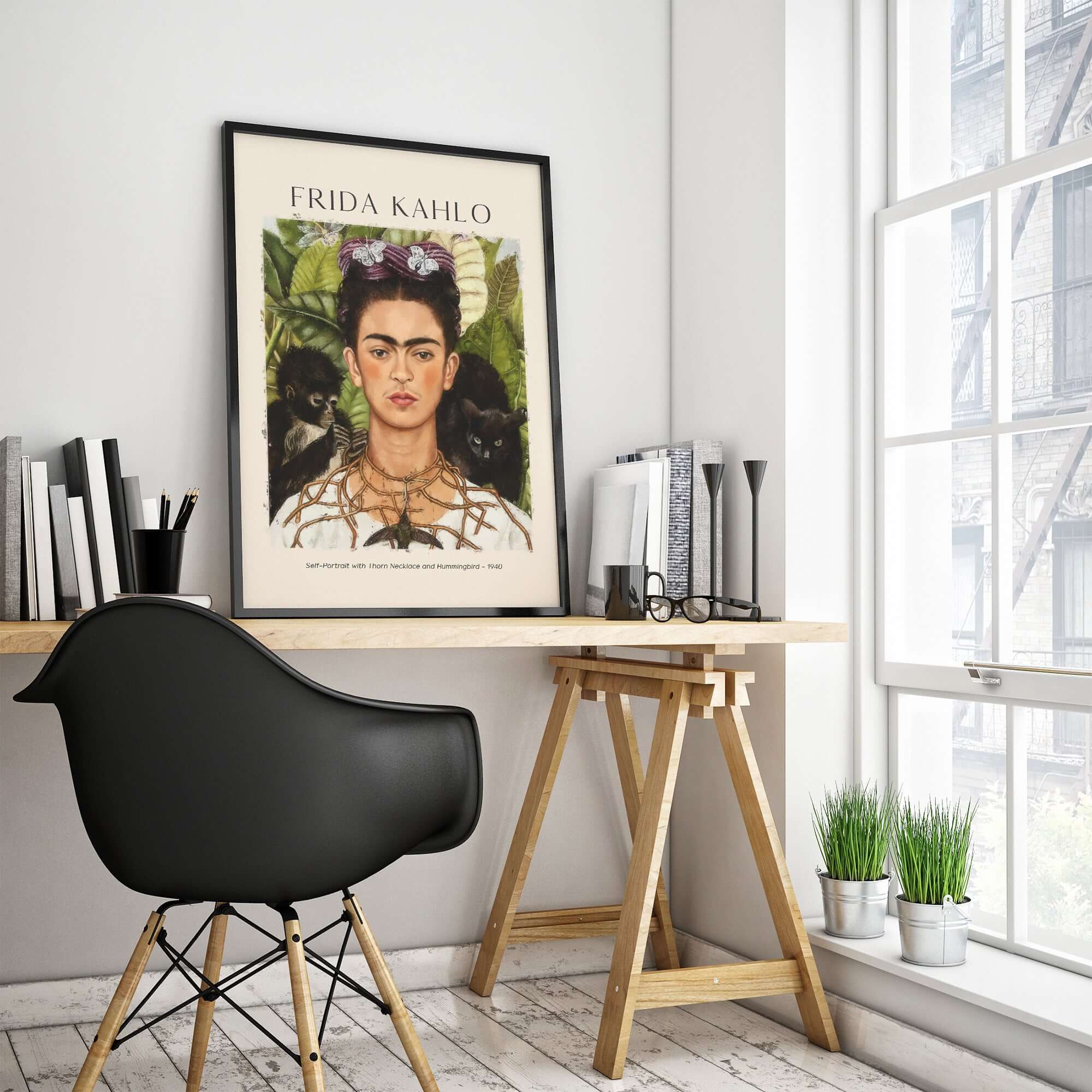 Frida Kahlo Self Portrait with Thorn Necklace and Hummingbird Print displayed in a modern workspace setting.