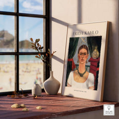 Frida Kahlo Self Portrait Time Flies 1929 Vintage Art Print Poster displayed on a wooden table near a window.