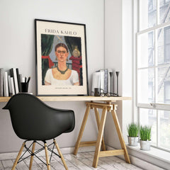 Frida Kahlo Self Portrait Time Flies 1929 Vintage Art Print Poster displayed in a stylish modern workspace.