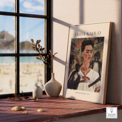 Frida Kahlo Self Portrait with Monkeys Famous Painting Poster Art Print displayed on a wooden table near a window.