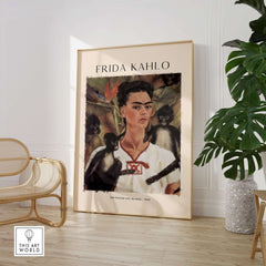 Frida Kahlo Self Portrait with Monkeys Famous Painting Poster Art Print displayed in a stylish interior, featuring tropical plants.