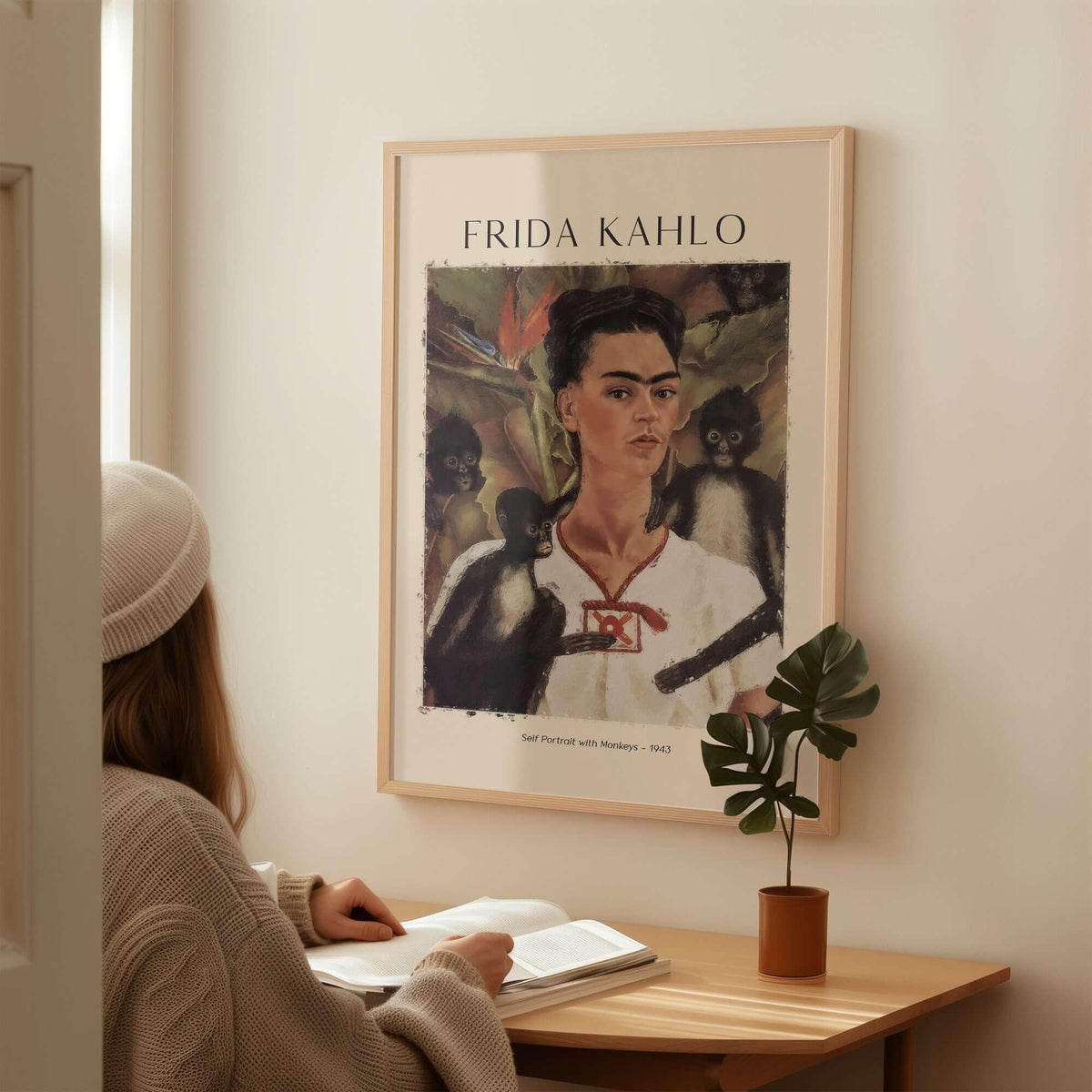 Frida Kahlo Self Portrait with Monkeys Famous Painting Poster Art Print displayed on wall, woman admiring the artwork.