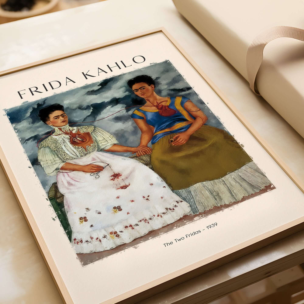 Frida Kahlo The Two Fridas Famous Art Print Poster Wall Art displayed on a table, showcasing the double self-portrait.