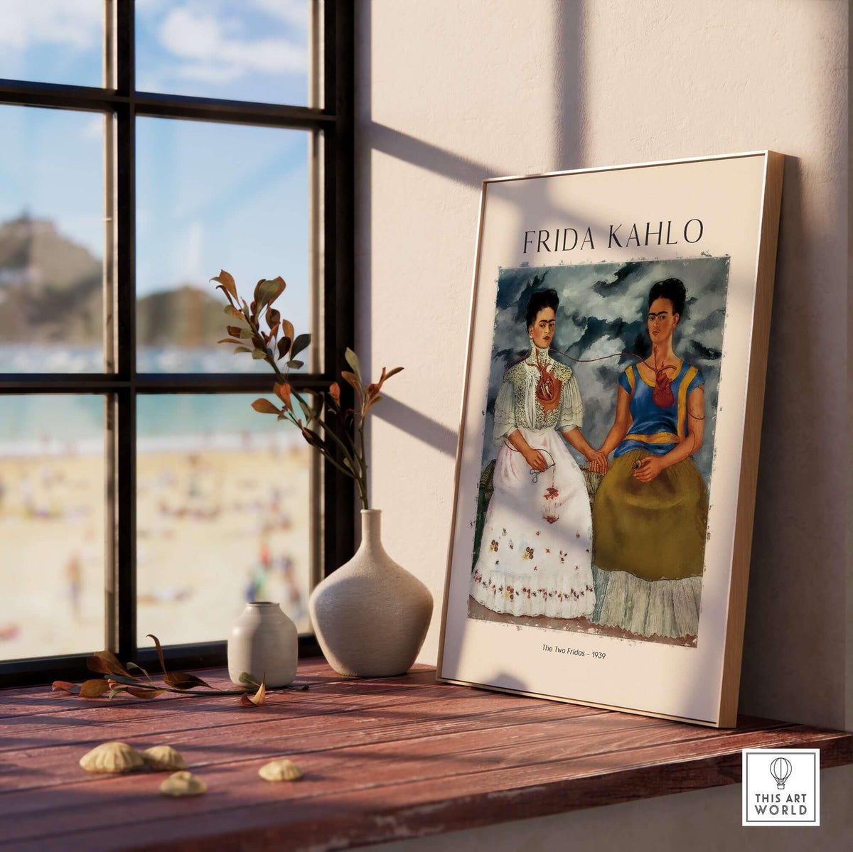 Frida Kahlo The Two Fridas Famous Art Print Poster Wall Art displayed in a bright room with a beach view.