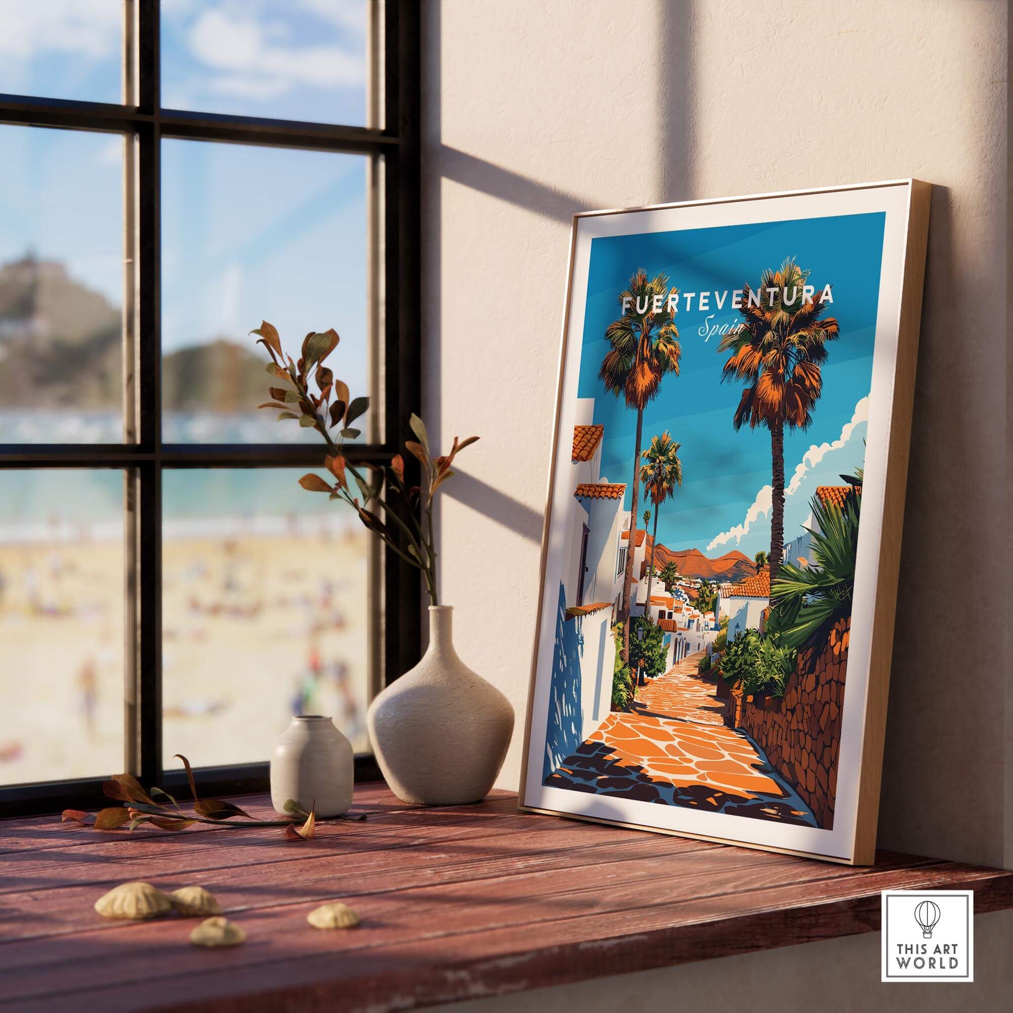 Fuerteventura Print Canary Islands Spain displayed on a windowsill with a beach view in the background.