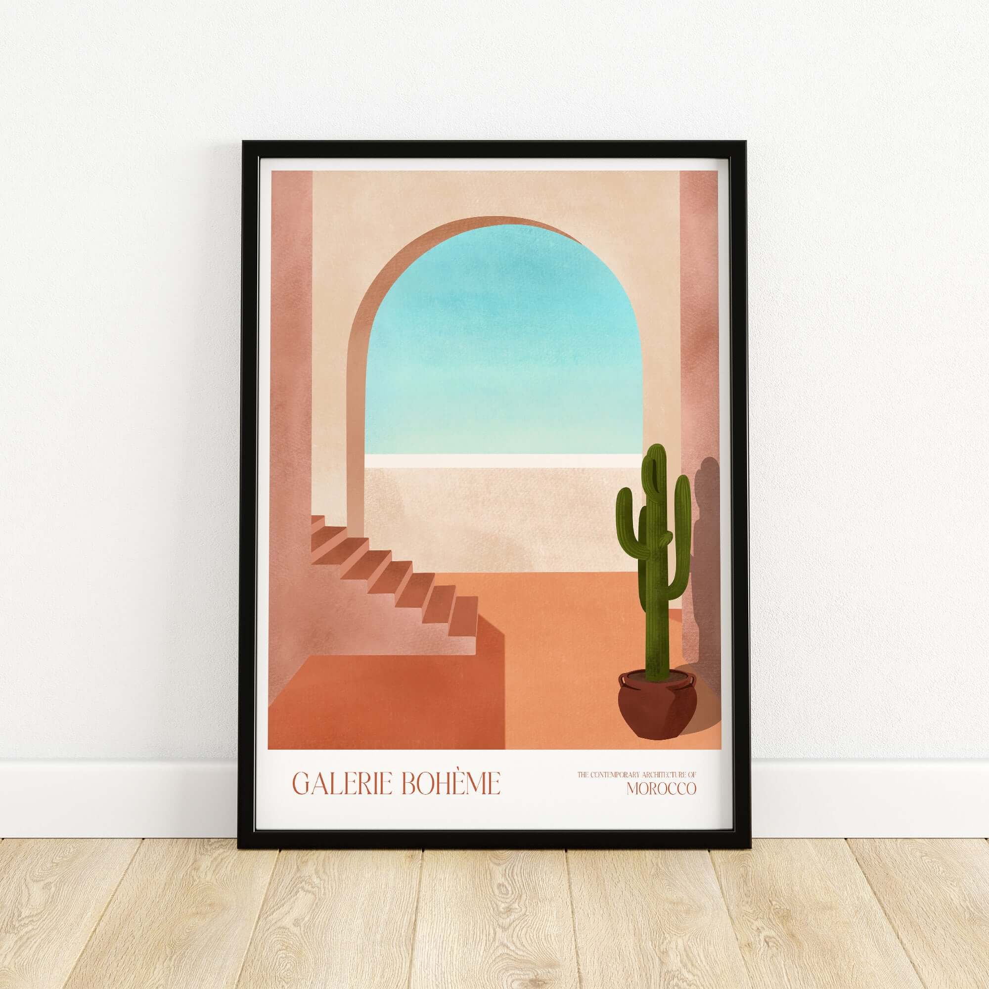 Galerie Bohème Moroccan Archway Cactus Art Print Terracotta Wall Decor Poster displayed in a modern frame on wooden floor.