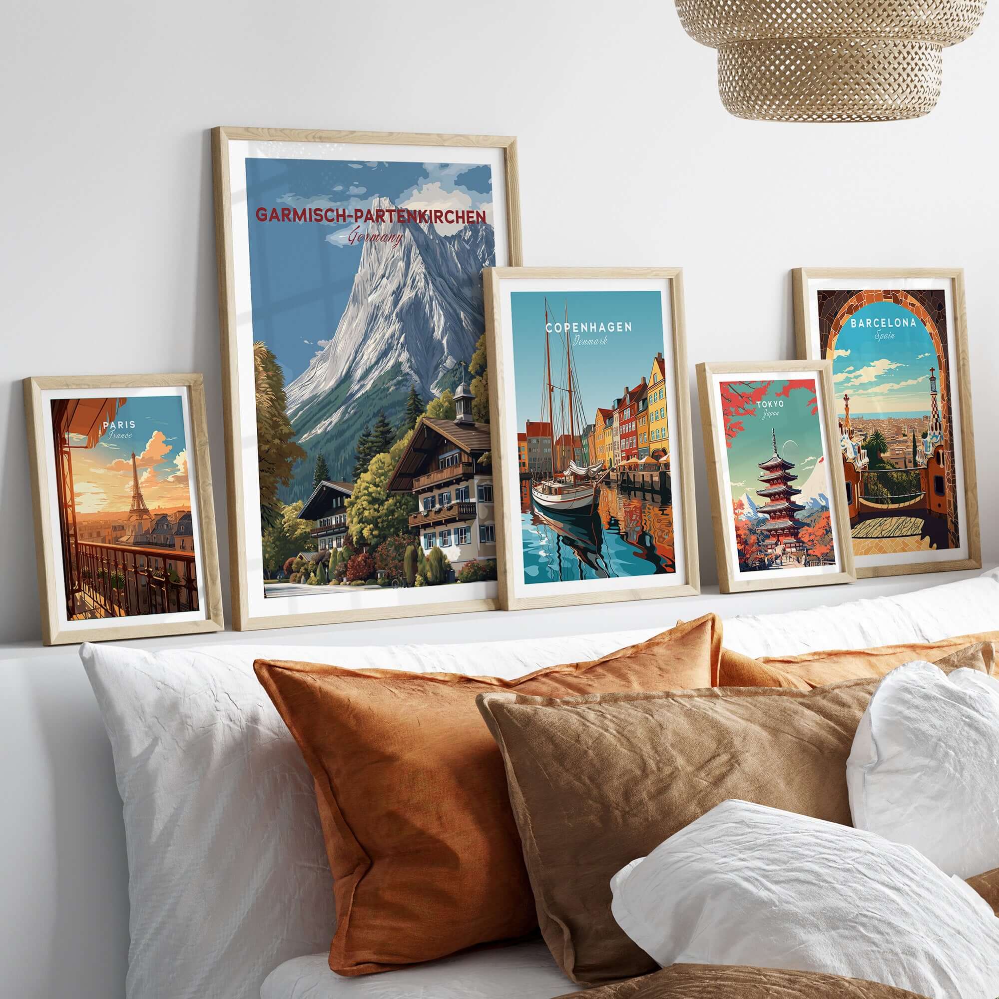 Garmisch-Partenkirchen Bavarian Alps View Print | Mountain Lodge Wall Decor framed with other city prints on a couch.