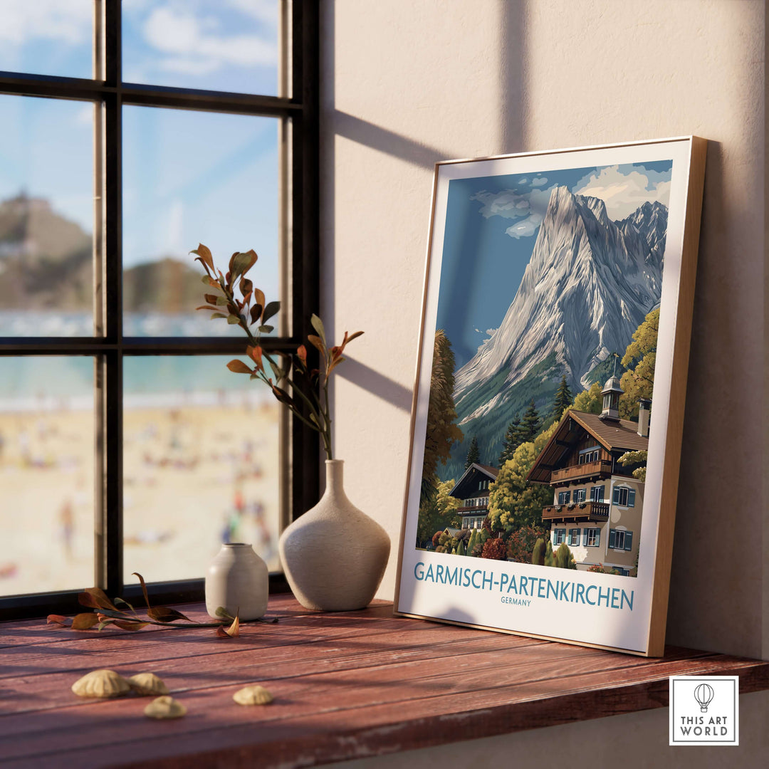 Garmisch-Partenkirchen Germany Mountain Town Art Print | Alpine Chalet Poster displayed by a sunny window.