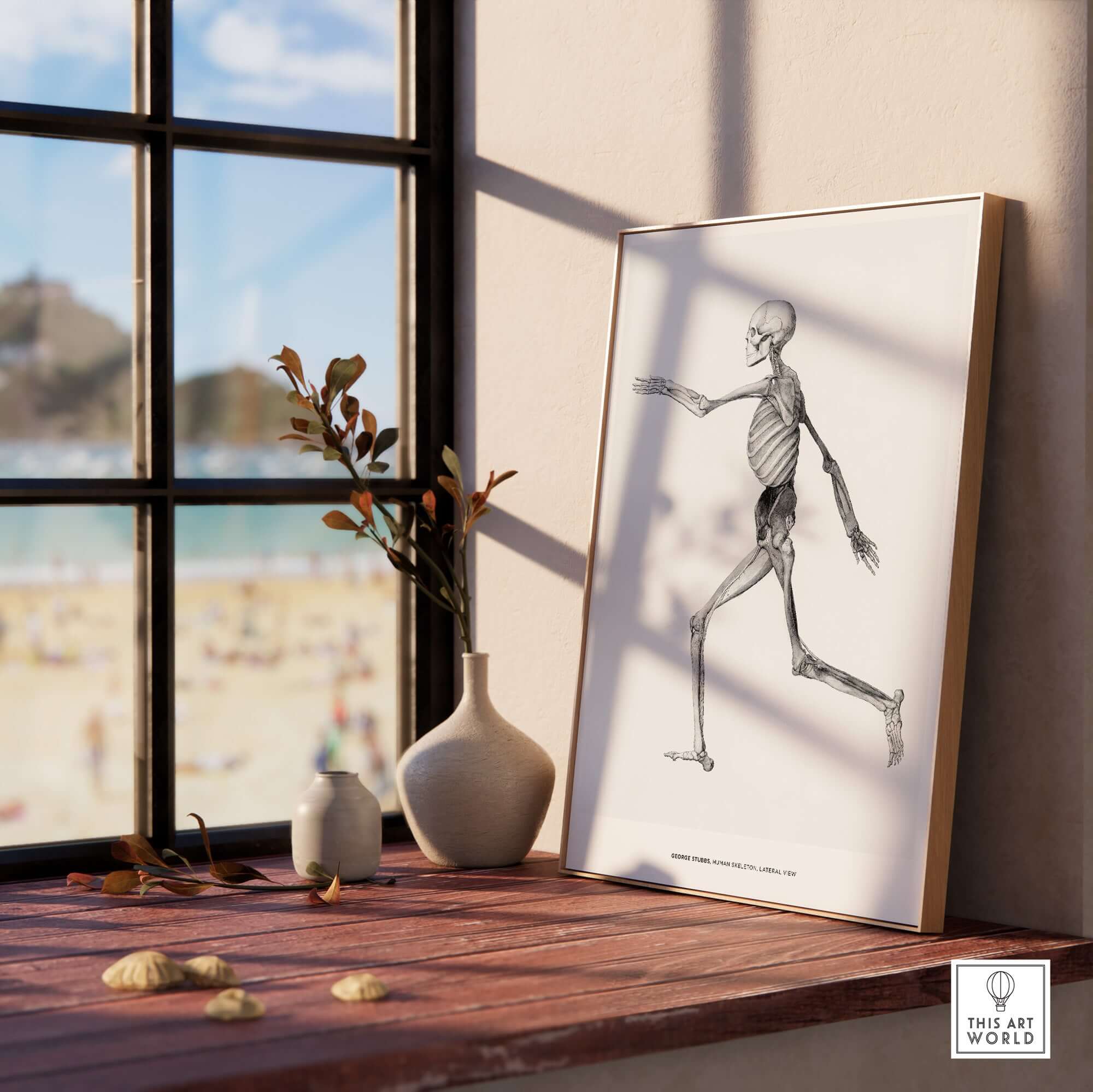 Exhibition Art Print George Stubbs Human Skeleton Lateral View Anatomy Poster framed on a windowsill with beach view.
