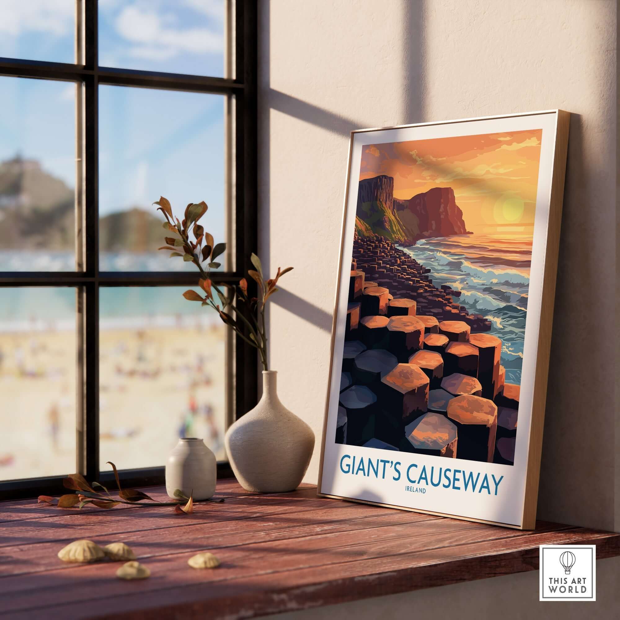 Giant's Causeway Art Print displayed on a shelf with a beautiful sunset scene of the iconic landmark.