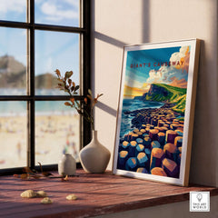 Giant's Causeway Travel Print displayed on a window sill with a scenic beach view.