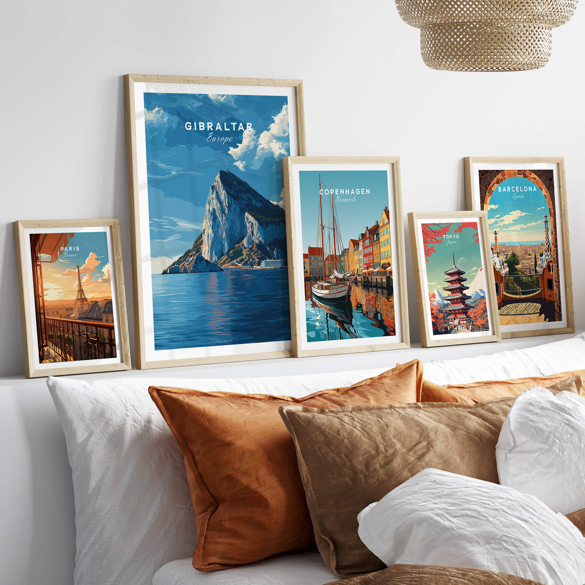 The Rock of Gibraltar Canvas Art Print and other travel-themed framed prints on a stylish couch.