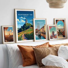 Glastonbury Tor Poster displayed among travel prints on a stylish bedroom wall.