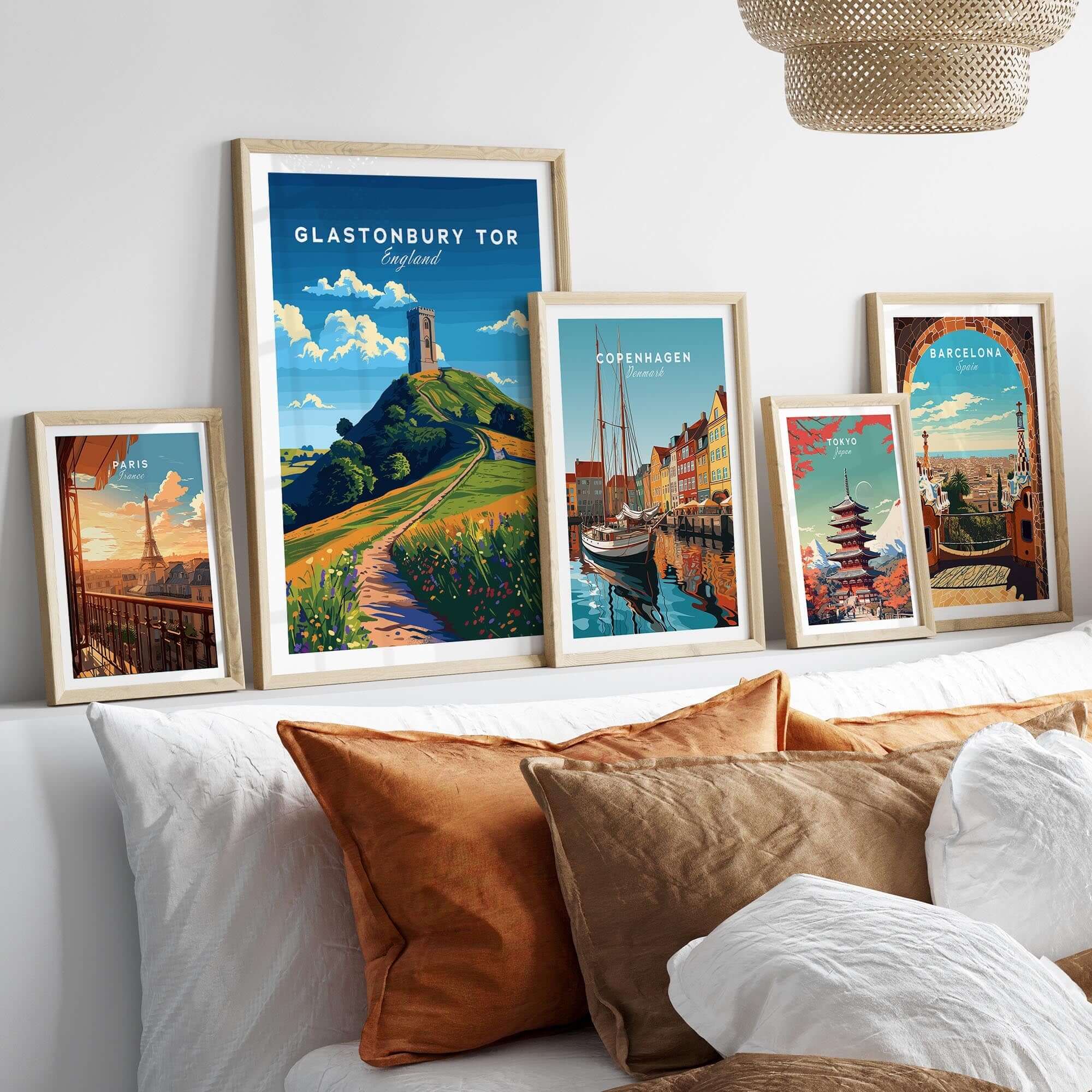 Glastonbury Tor Poster displayed among travel prints on a stylish bedroom wall.
