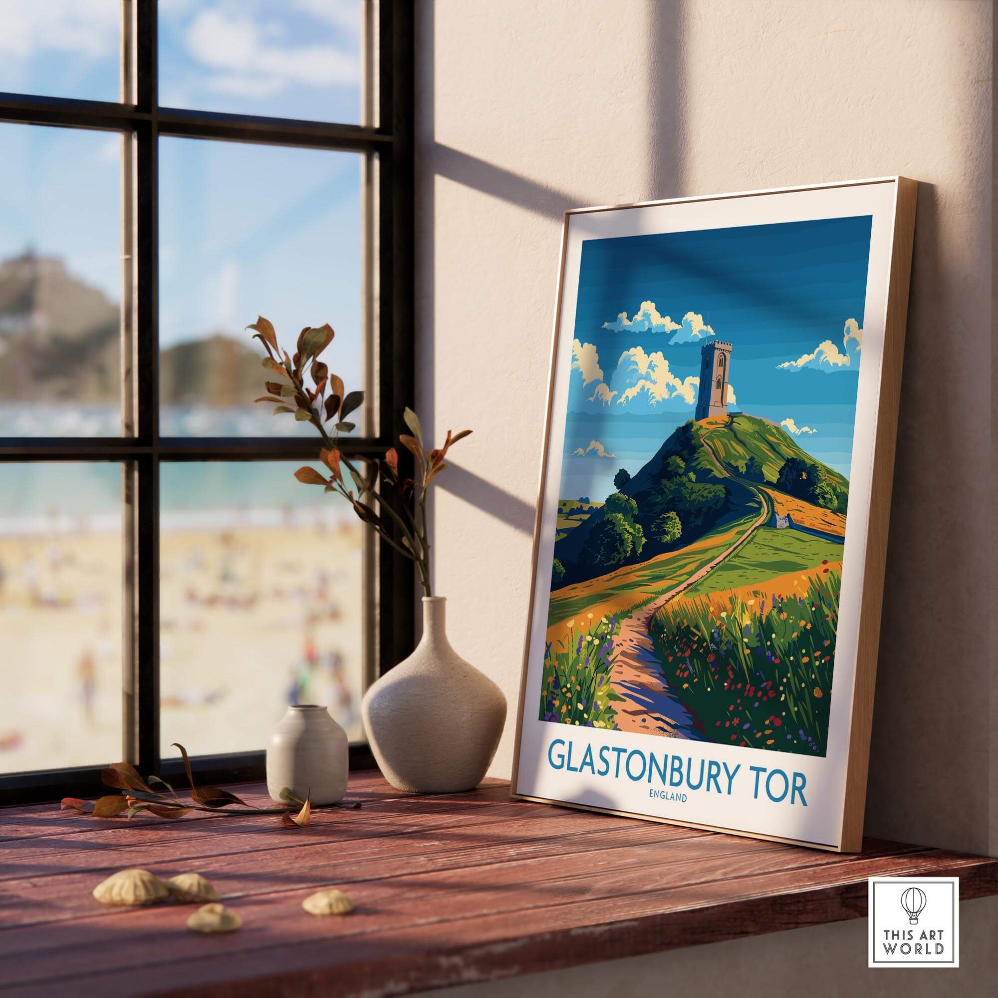 Glastonbury Tor Wall Art Print displayed in a cozy interior with a view of the outdoors.