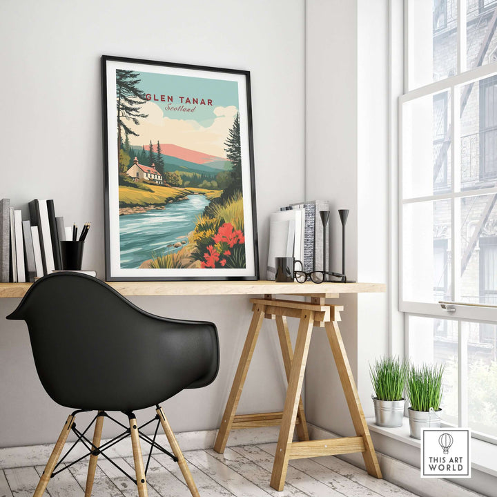 Glen Tanar Scotland poster displayed in a modern office, featuring a serene landscape with a river and mountain backdrop.