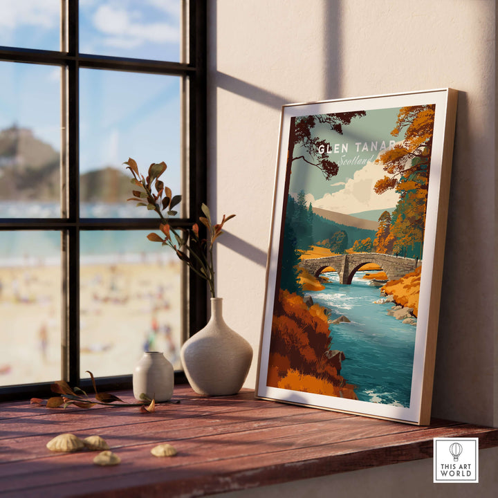 Framed Glen Tanar wall art showcasing a bridge over a river with lush trees, enhancing interior decor with Scottish beauty.