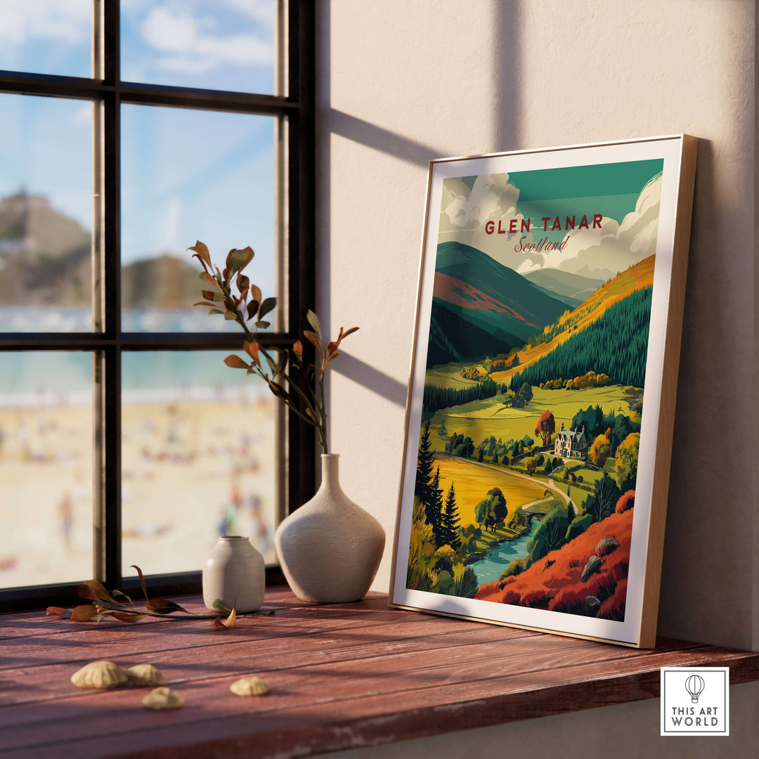 Glen Tanar travel print framed on a windowsill overlooking scenic Scottish Highlands landscape.