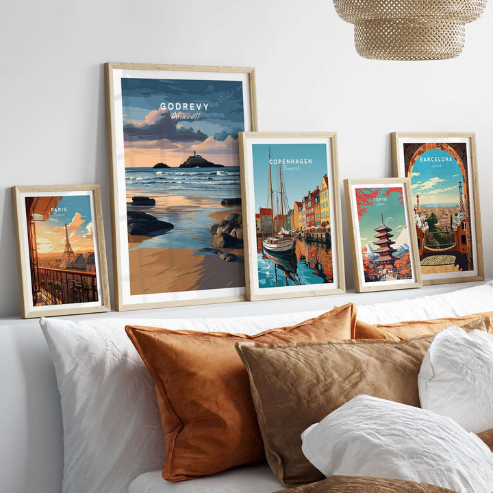 Gallery of framed travel posters featuring Godrevy Lighthouse, Copenhagen, Barcelona, and more in a cozy living room setting.
